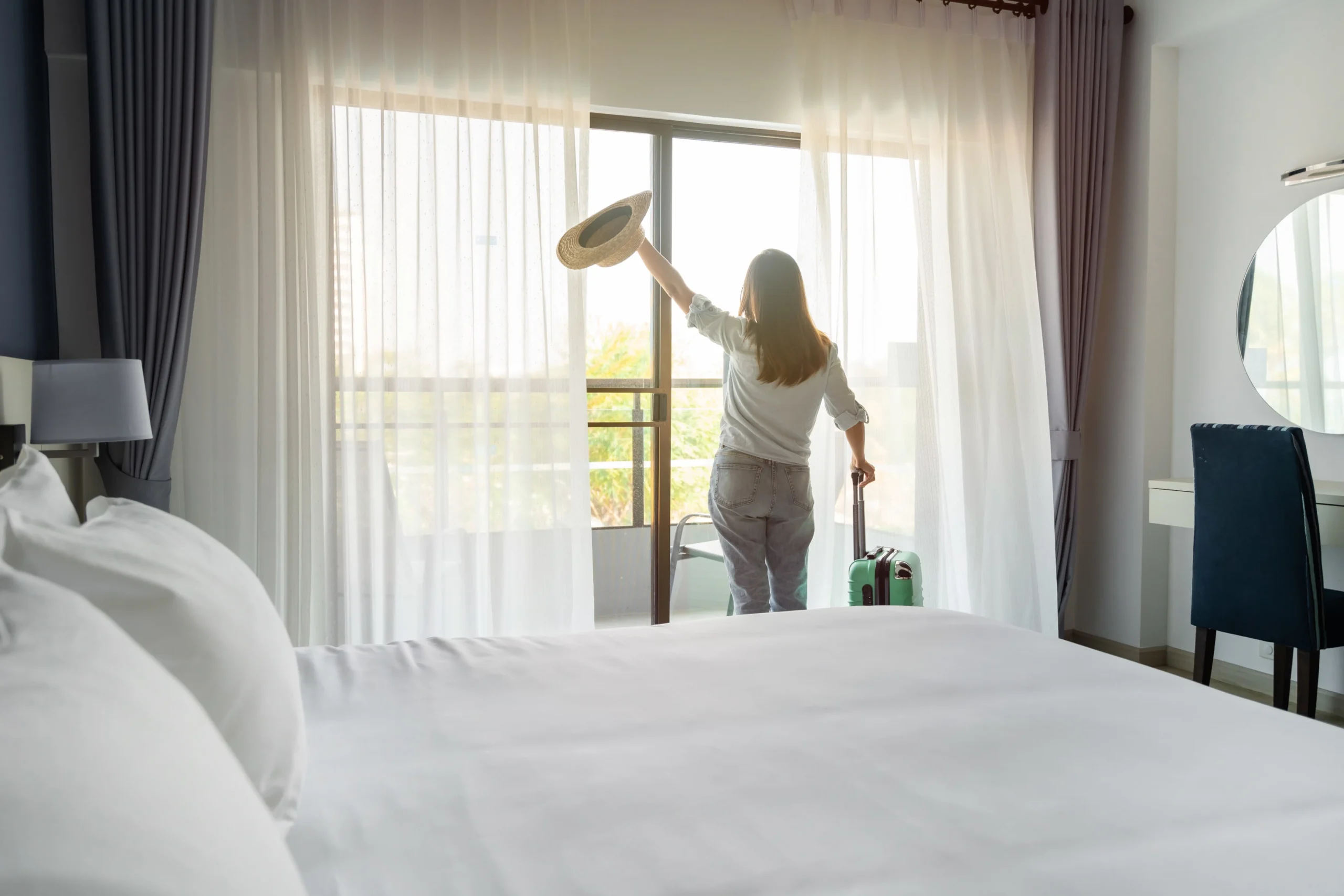 Guest enjoying fresh air and a clean hotel room after eco-friendly cleaning in Miami.