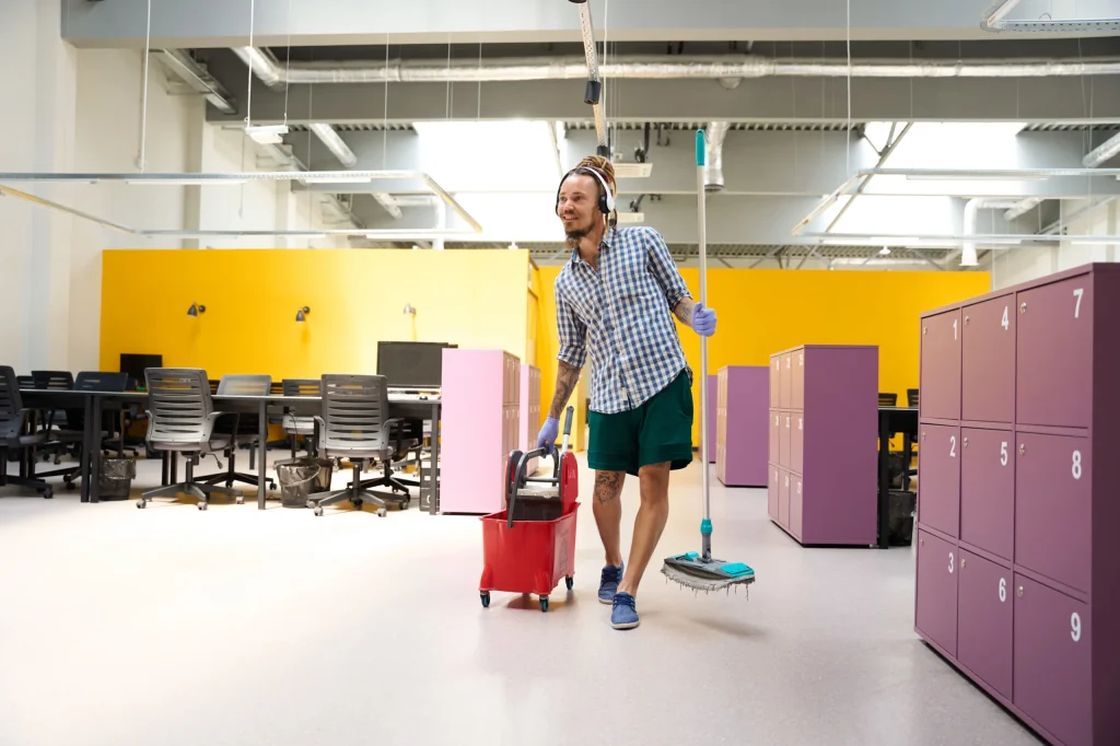 Janitor cleaning school floors with mop and bucket to reduce germs and ensure a clean learning space