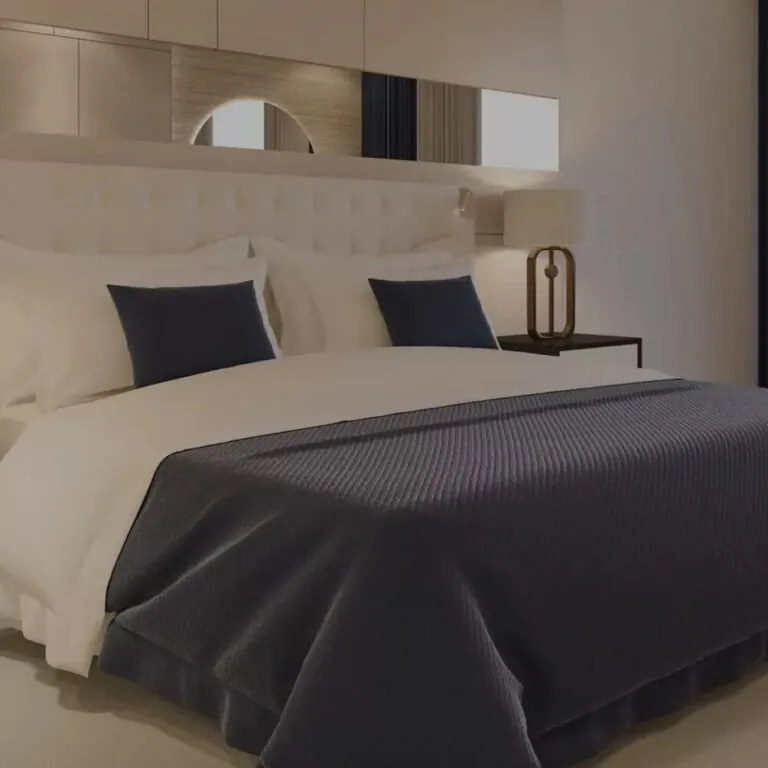 tidy hotel bedroom showcasing a comfortable bed and a mirror, emphasizing cleanliness and modern design.